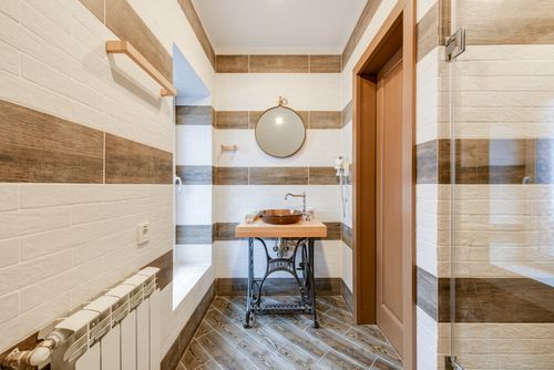 Free Stylish bathroom with upcycled sink table and round mirror. Stock Photo