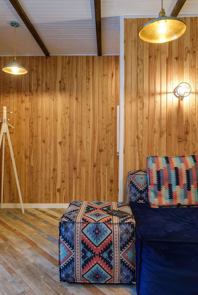 Wooden Panels On Walls And Patterned Colorful Couch