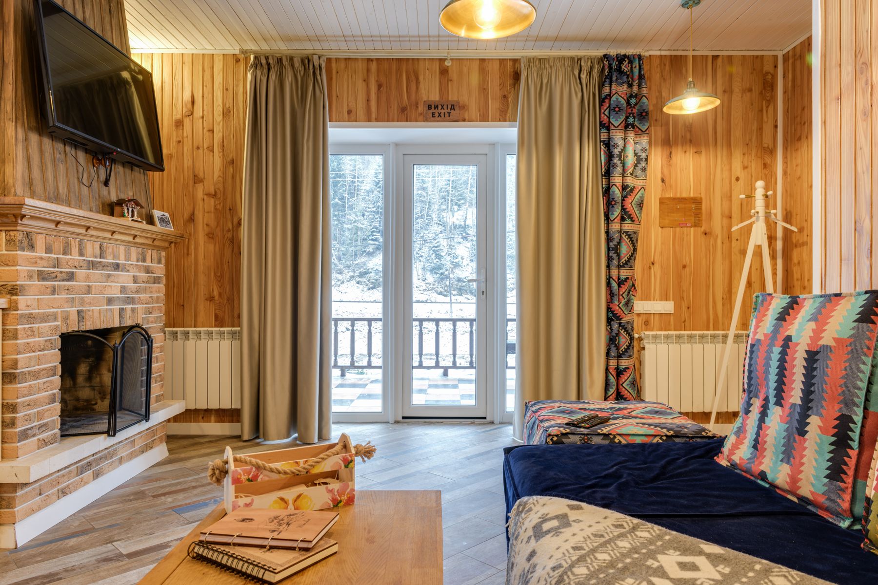 Warm wood living room with fireplace, patterned textiles and natural materials