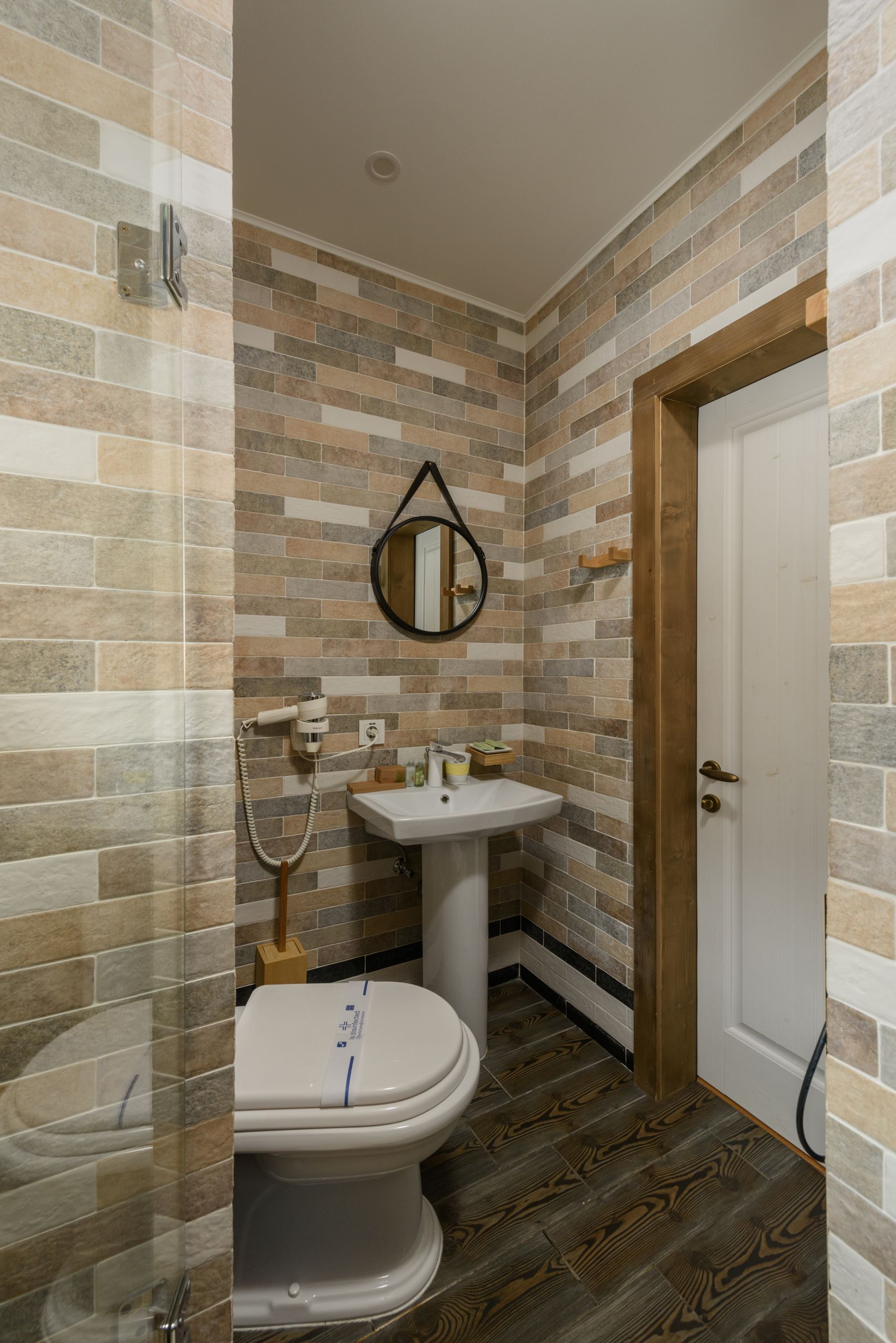 Bathroom vanity with geometric round mirror and warm wood
