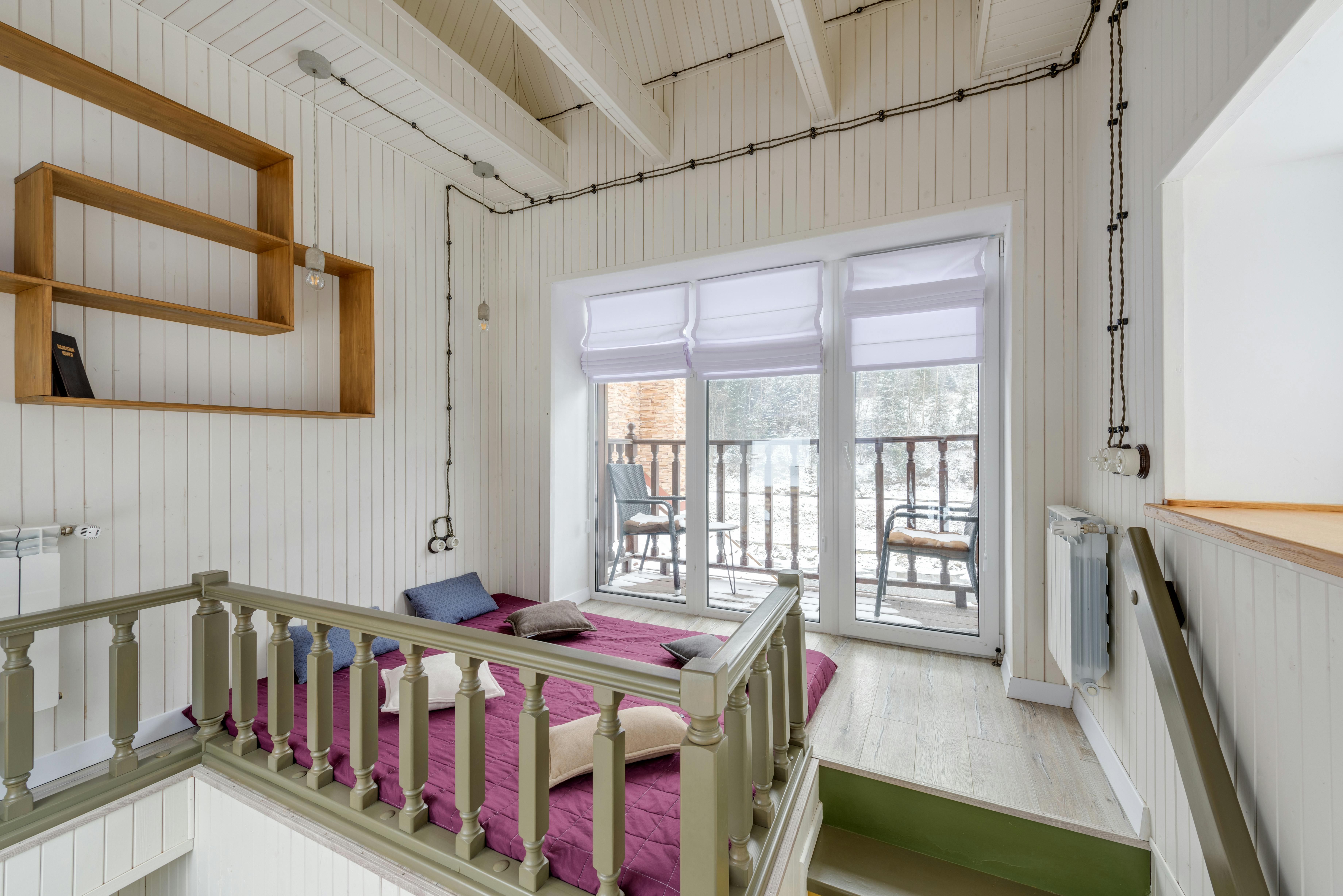 Interior view of Bay Cottage loft showing queen bed and storage solutions - Tiny house San Francisco