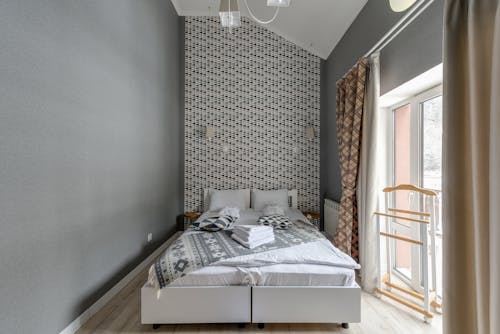 Free A Gray and White Painted Bedroom with Double Bed  Stock Photo