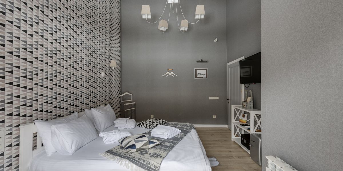 Stylish modern hotel bedroom with neutral decor and large window