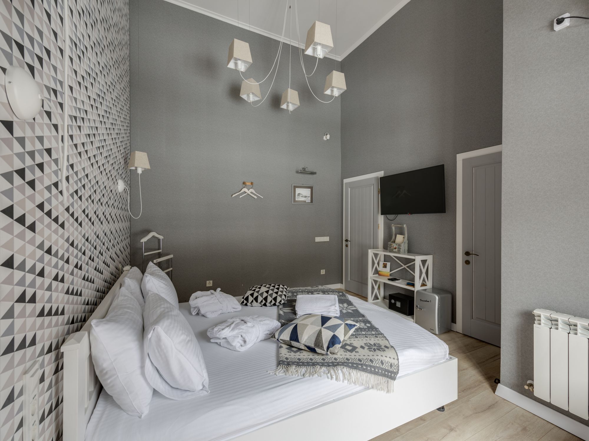 Wallpapering in Wapping, Tower Hamlets — decorator hanging pattern-matched wallpaper