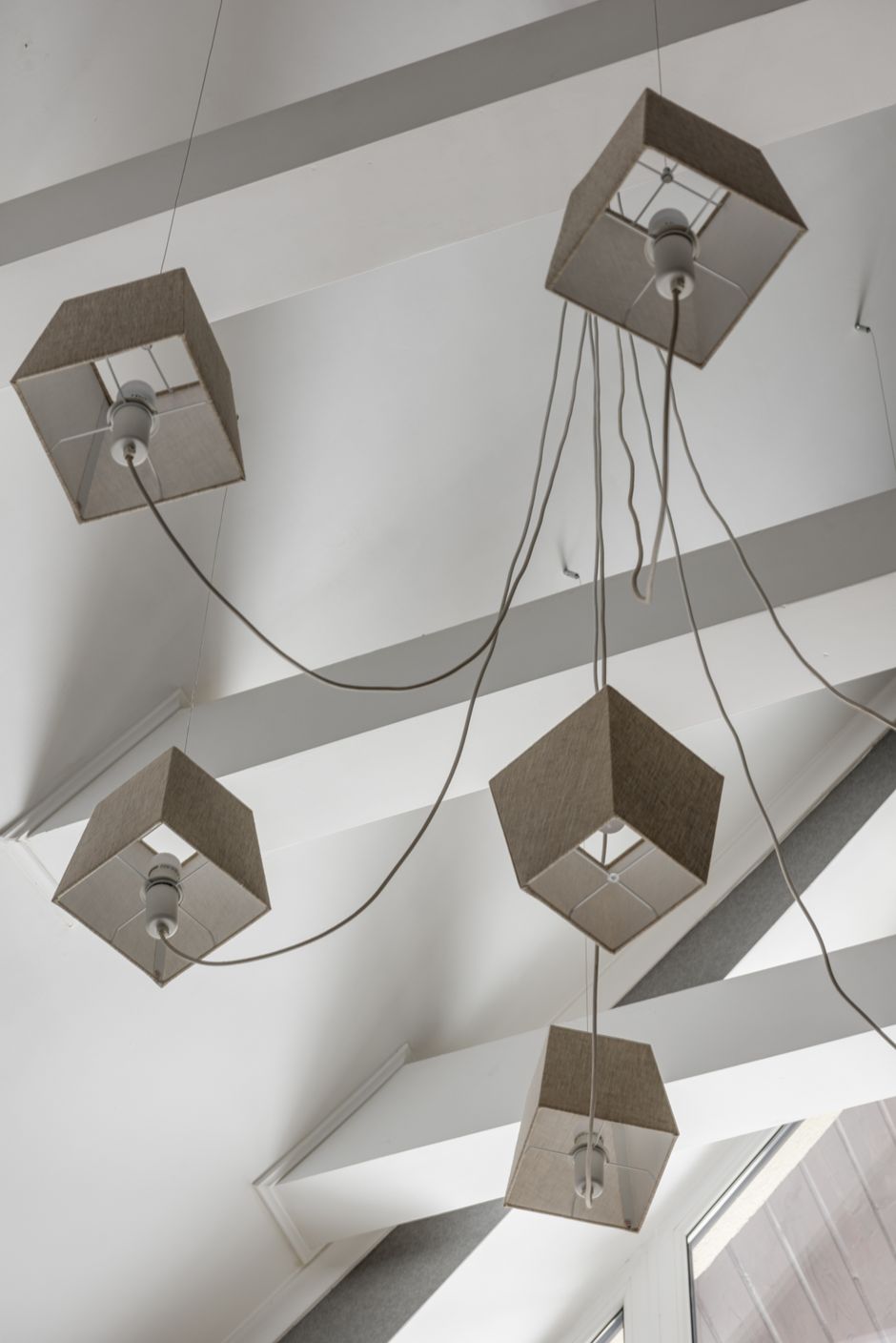 Modern ceiling lights with geometric design in a stylish interior setting.