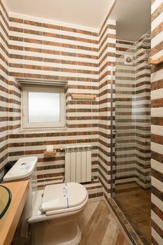 Contemporary bathroom featuring a tiled design and shower cabin.