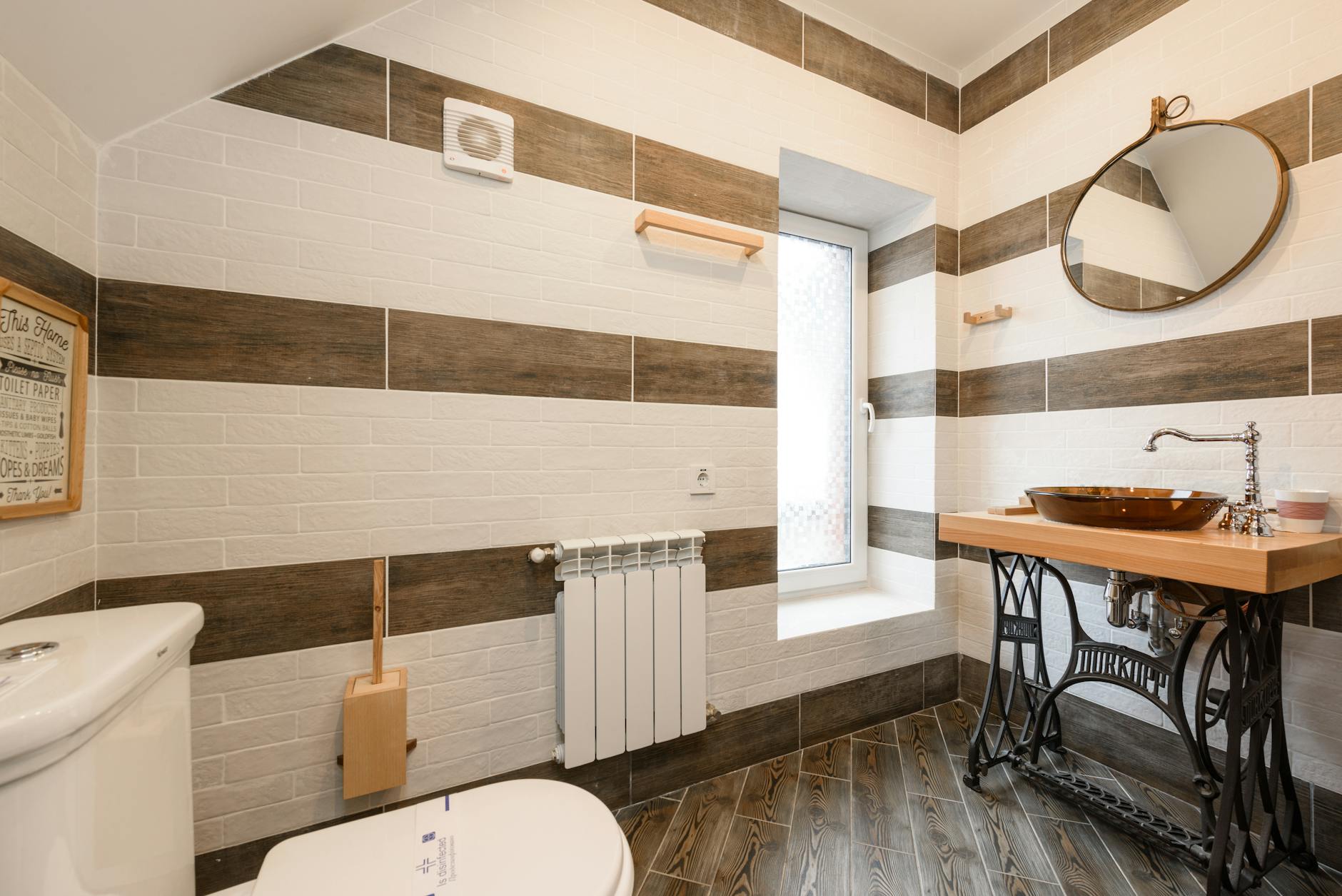 Elegant bathroom featuring a rustic wood vanity and modern fixtures in natural light.