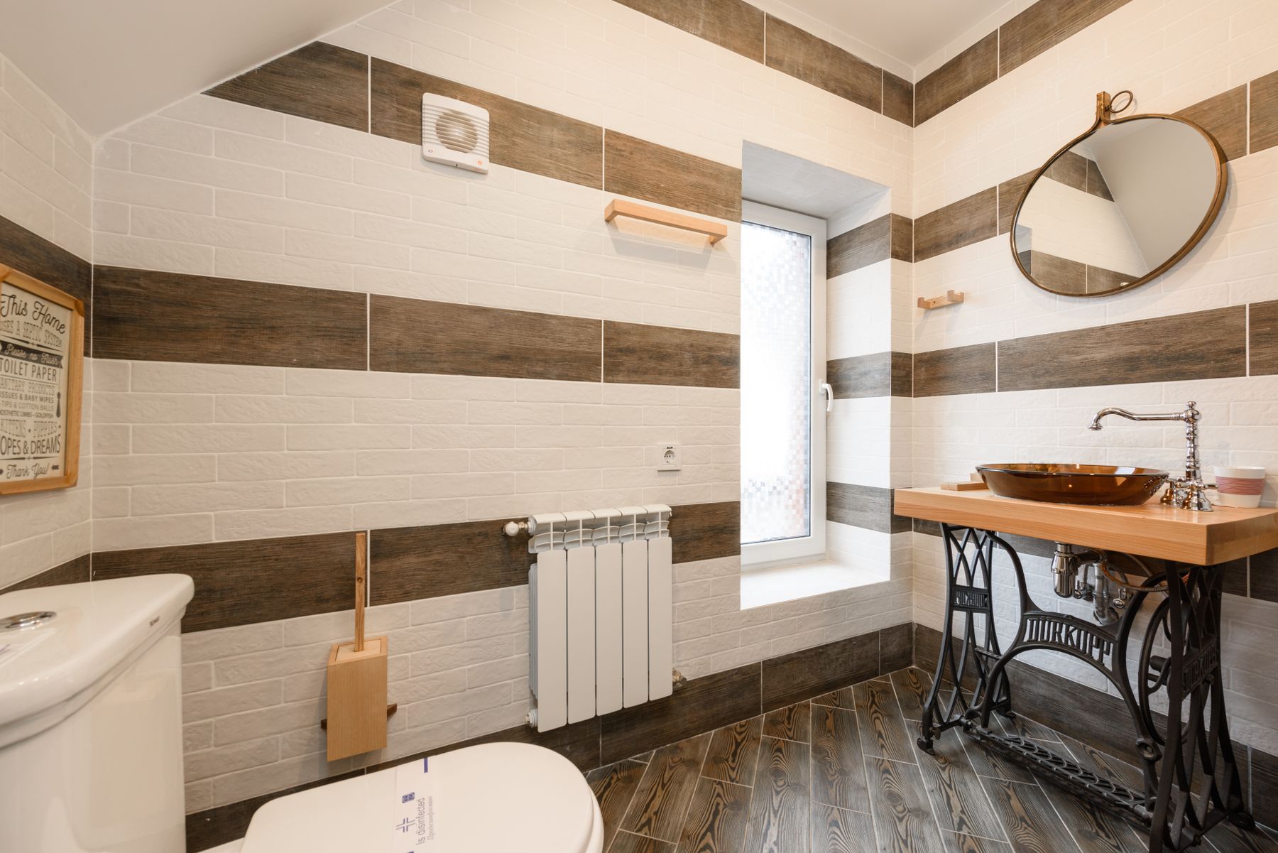 Warm wood vanity in a bright bathroom with pale surrounding finishes
