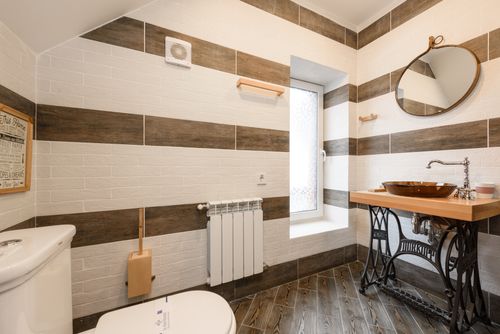Free Elegant bathroom featuring a rustic wood vanity and modern fixtures in natural light. Stock Photo