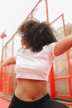 Close-up of an African American woman exercising outdoors, showcasing fitness and health.