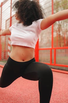 Young woman stretching outdoors in athletic wear, promoting fitness and wellness.