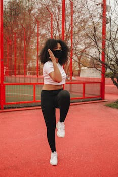 African American woman exercising outdoors with a face mask.