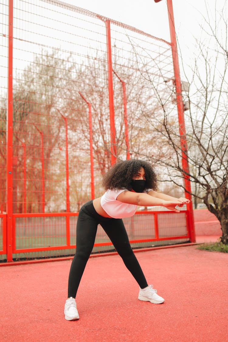 A Woman In White Crop Top Doing An Exercise