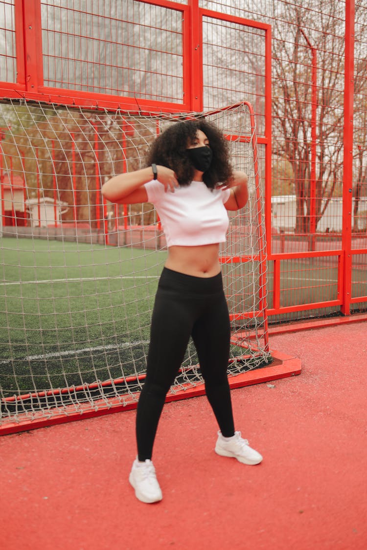 Woman Standing Near Football Goal