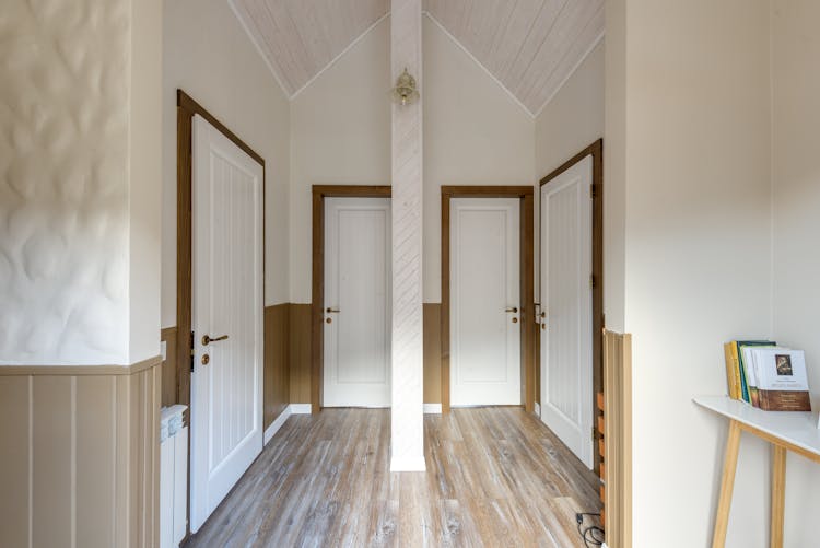 Photograph Of A Hallway With White Doors