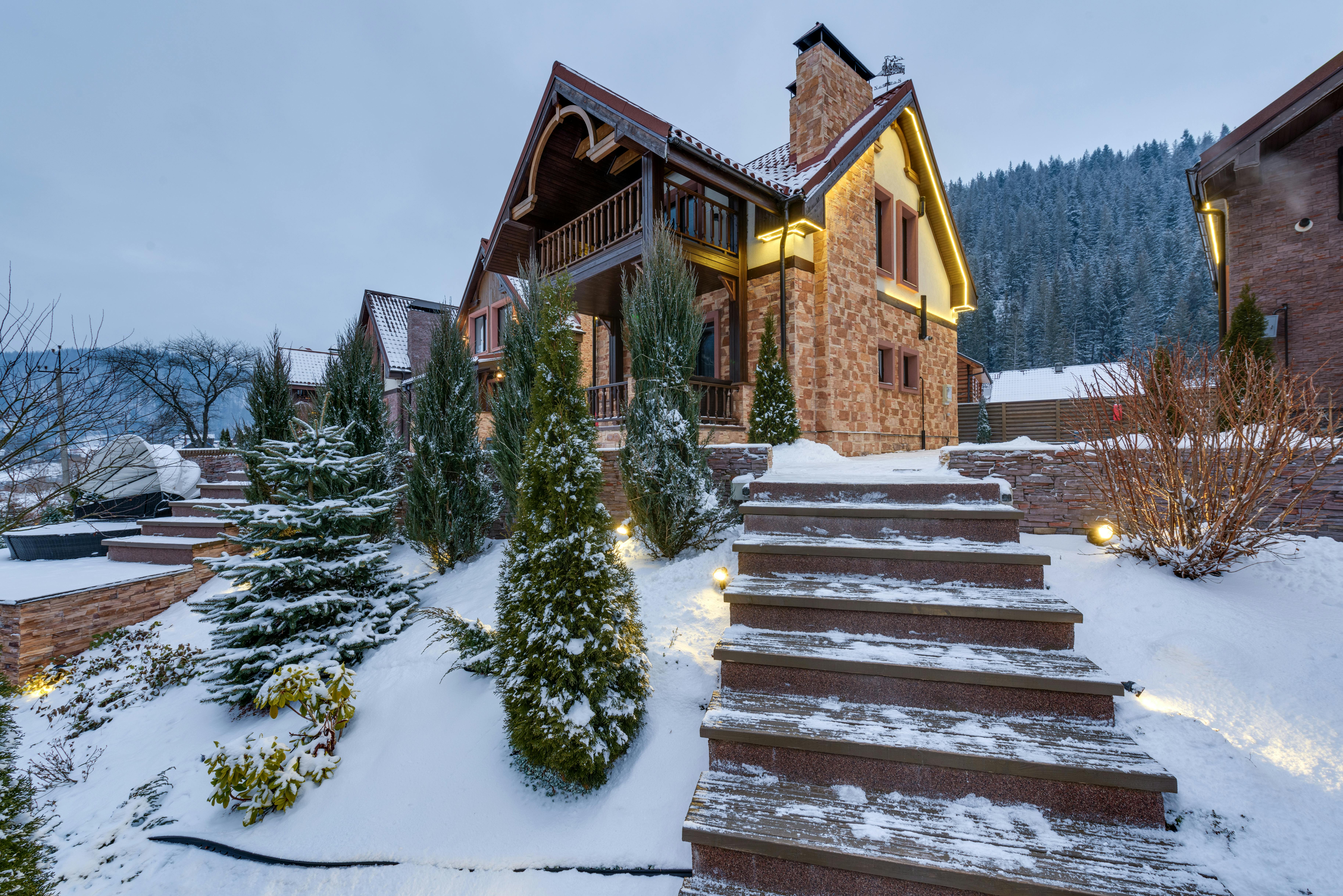 Beautiful snow-covered chalet nestled in the winter mountains, surrounded by nature.