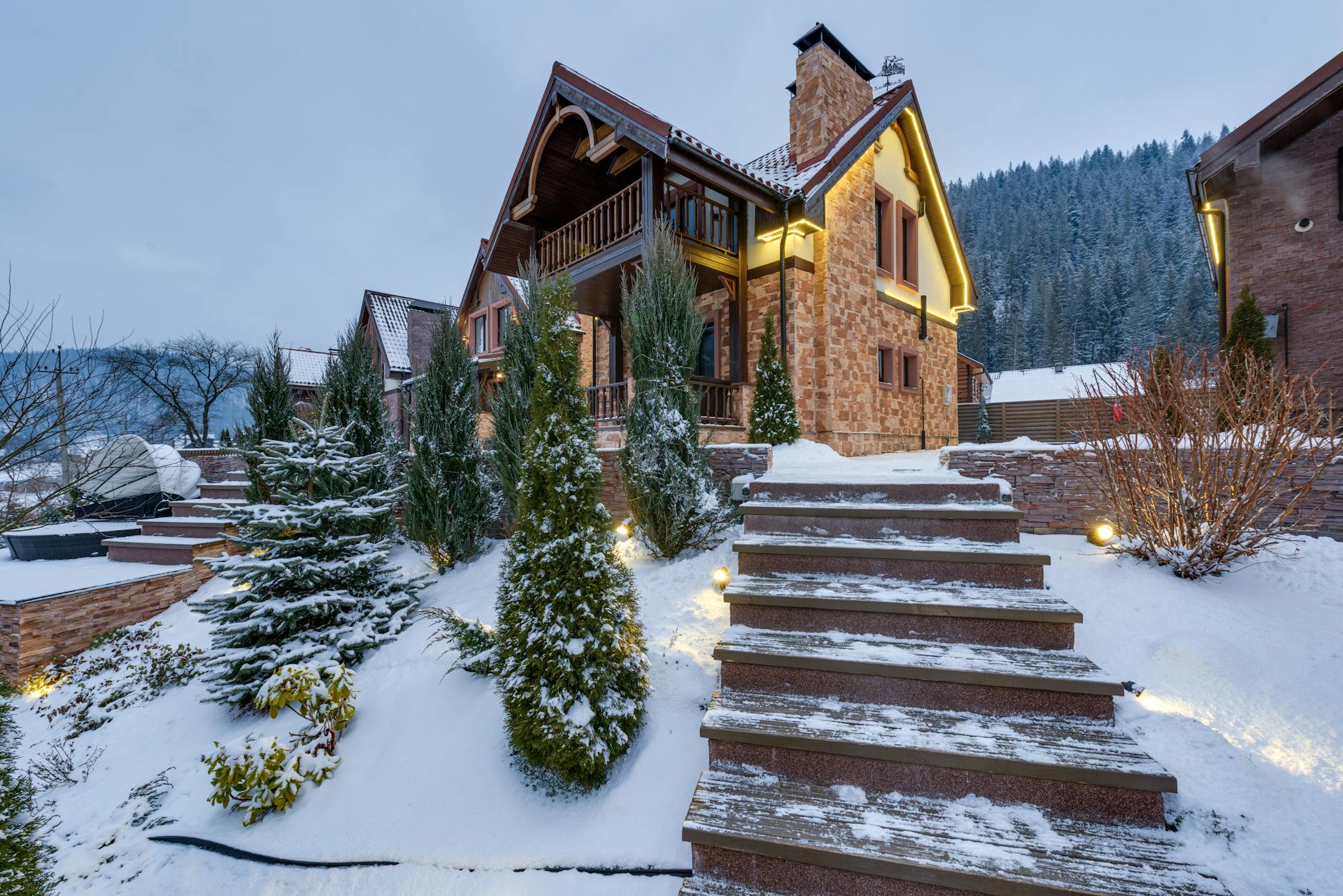 Beautiful snow-covered chalet nestled in the winter mountains, surrounded by nature.