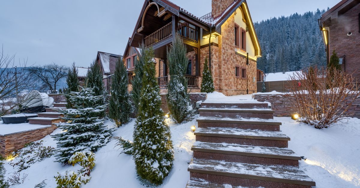 Beautiful snow-covered chalet nestled in the winter mountains, surrounded by nature.