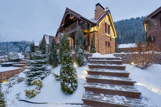Beautiful snow-covered chalet nestled in the winter mountains, surrounded by nature.
