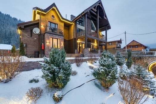 Charming wooden house with a snowy landscape, perfect for winter retreats.