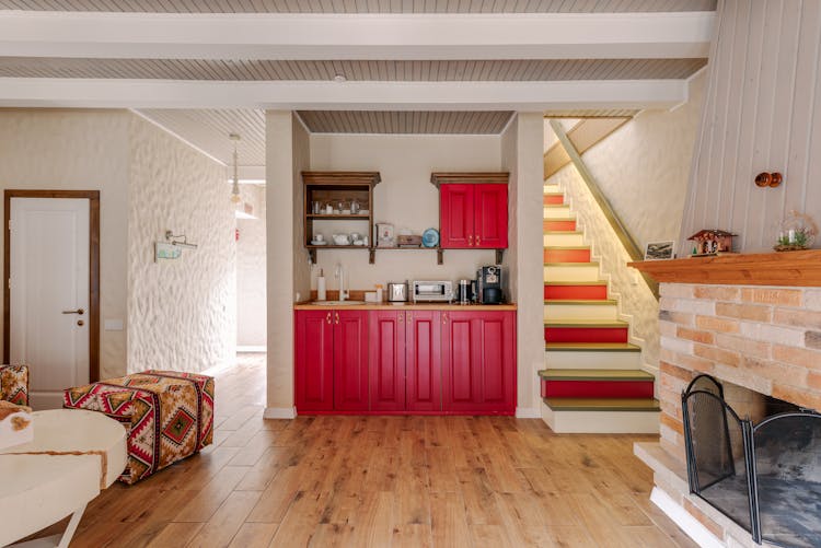 Kitchen  With Red Wooden Cabinet Near Fireplace 