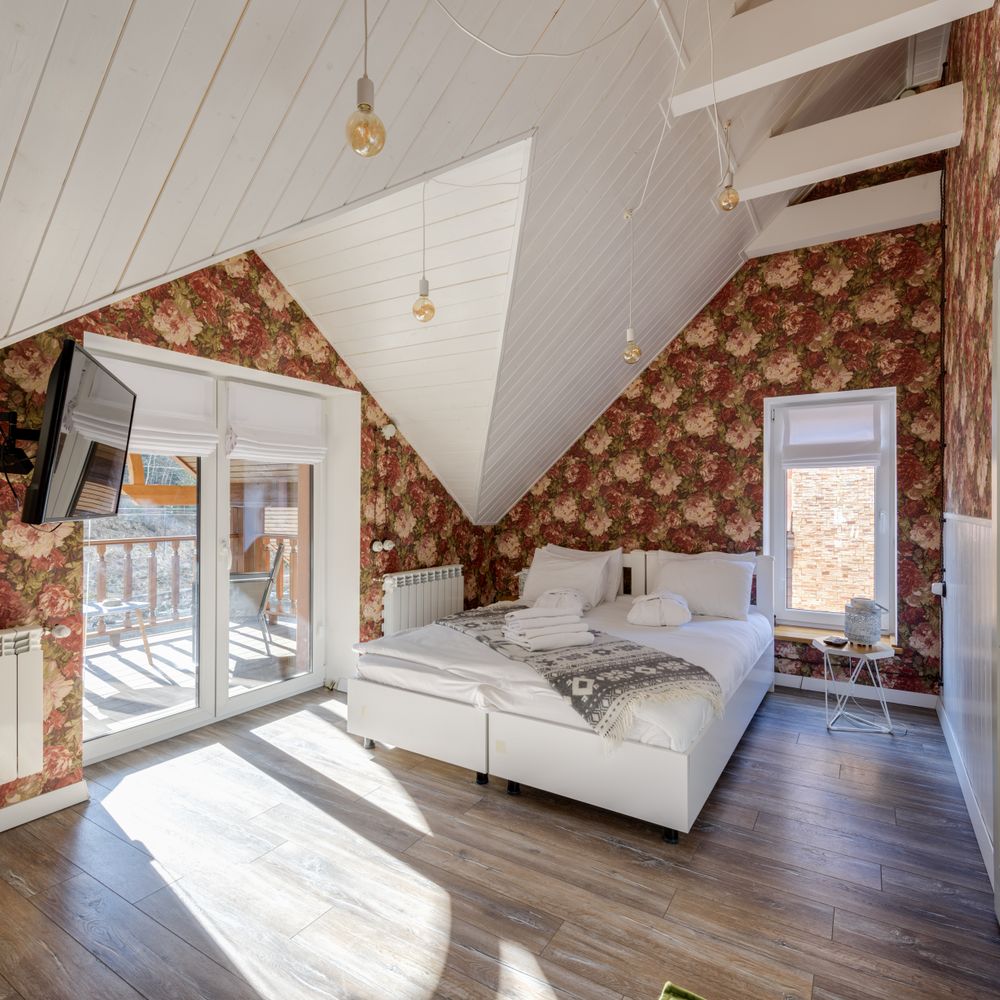 Sunlit bedroom finished with elegant floral wallpaper