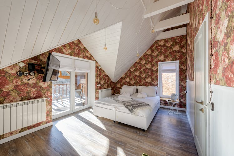 White Themed Attic Bedroom With Floral Wallpaper