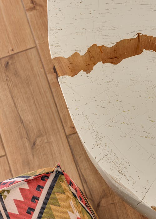 Broken White Table on Wooden Floor