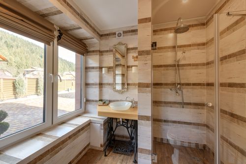 Free Stylish bathroom featuring a shower and mirror with natural light. Stock Photo