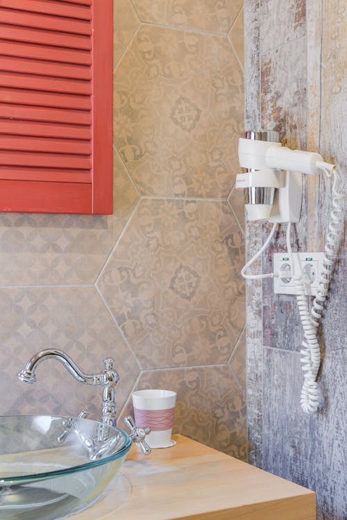 White and Silver Hair Dryer Mounted on Wall