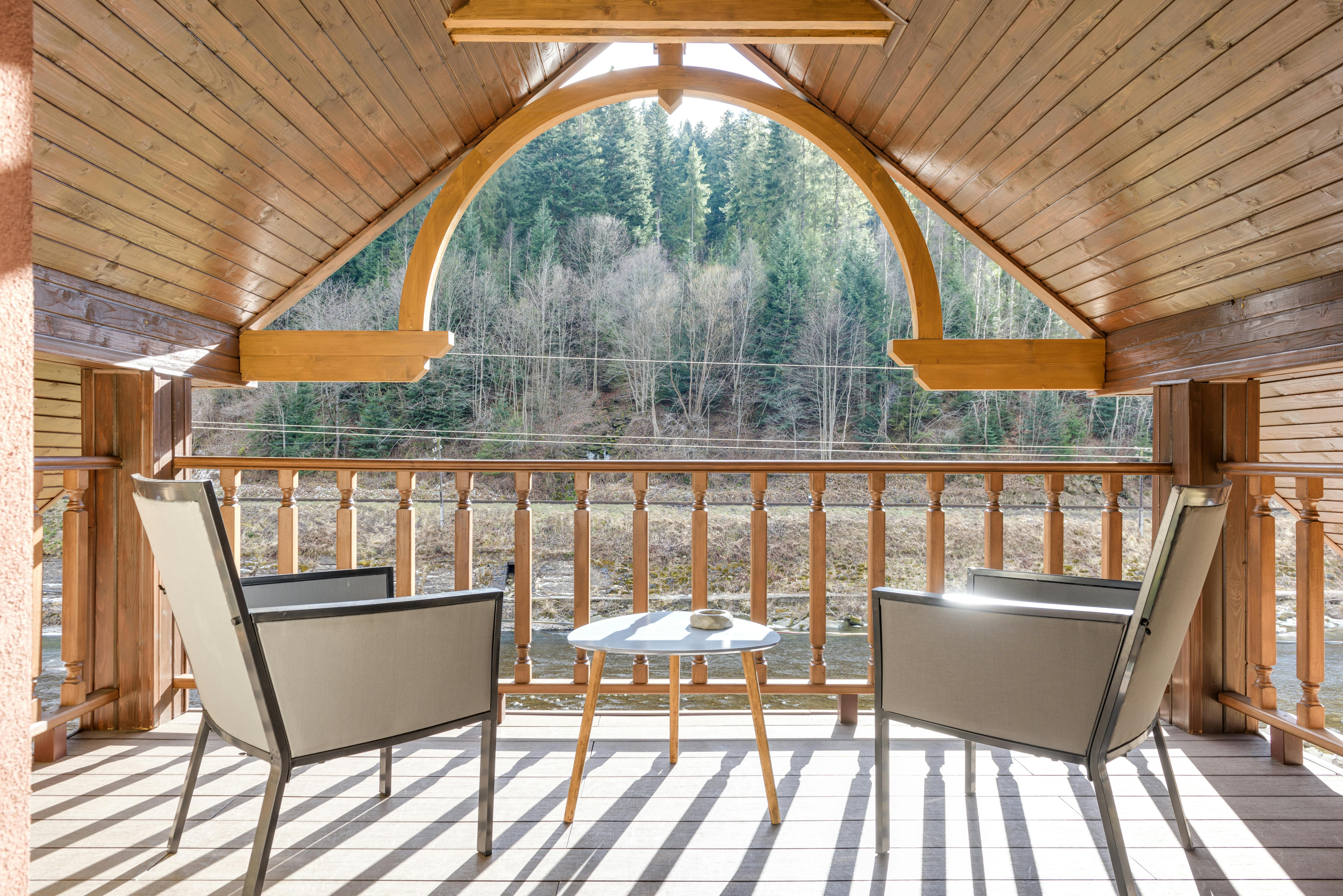 Free Wooden Balcony on Attic with Steel Framed Chairs Stock Photo