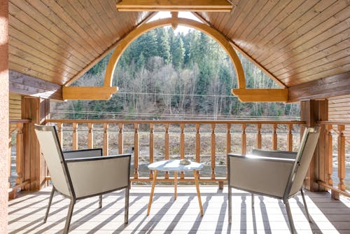 Wooden Balcony on Attic with Steel Framed Chairs