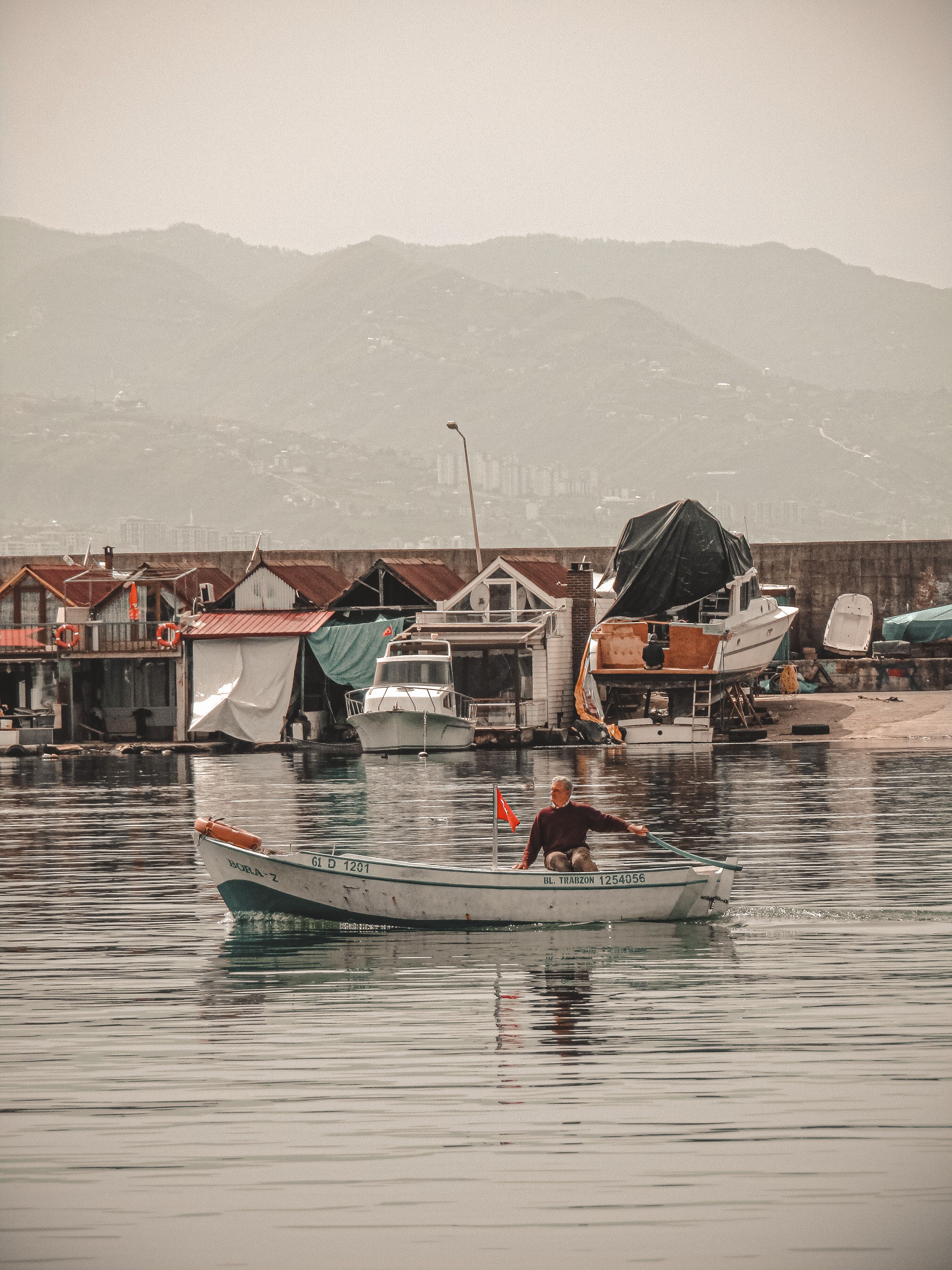 Man Riding White Boat on Water · Free Stock Photo
