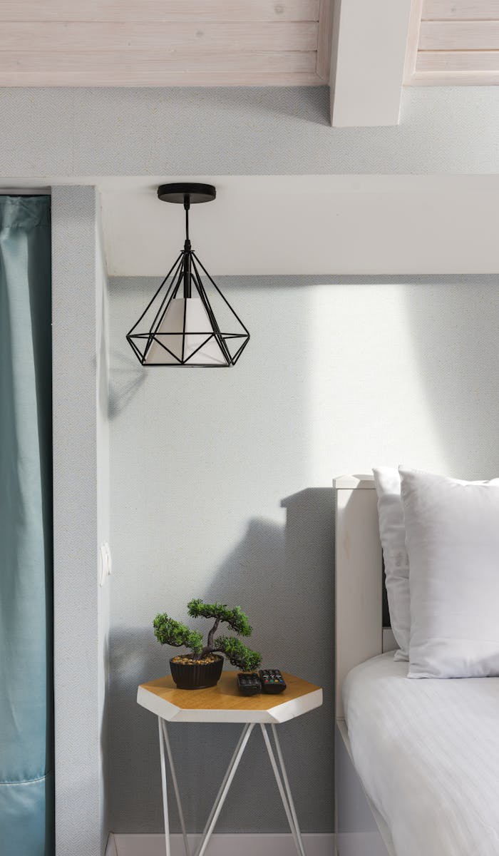 Small bonsai tree on a modern bedside table in a minimalist bedroom