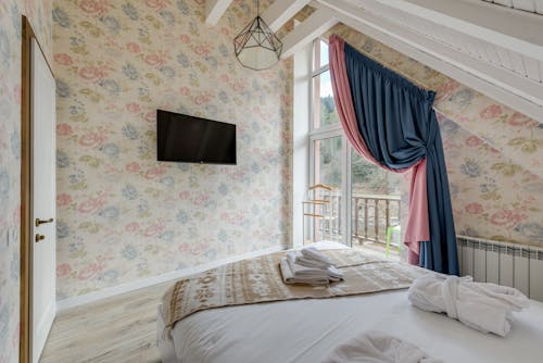 A Bedroom with a Floral Wall