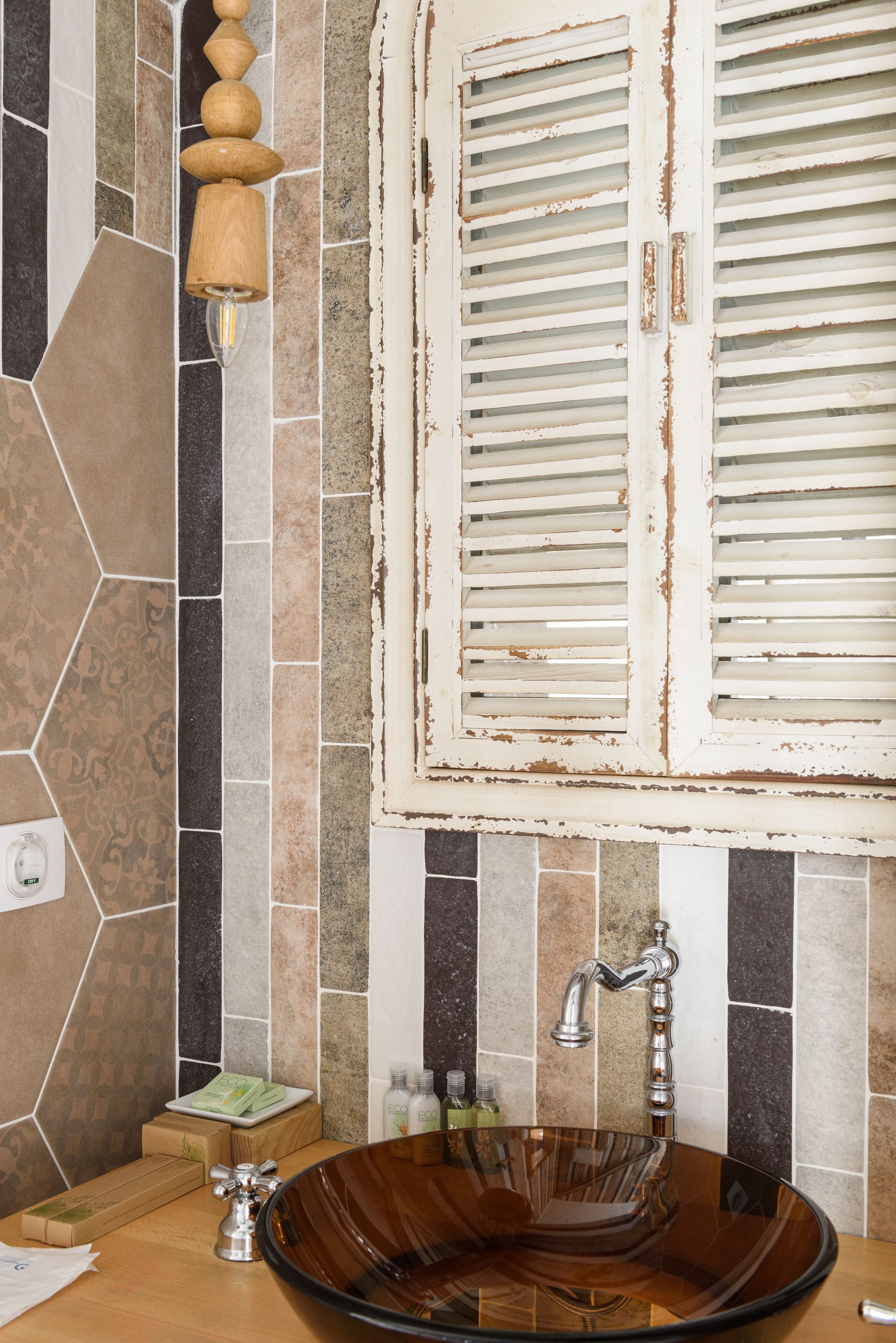 Compact guest powder room with decorative sink, mirror and characterful wall treatment