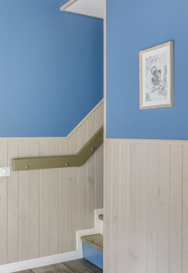 Stairway with wooden panelling and deep blue walls, photo by Max Vakhtbovych on Pexels