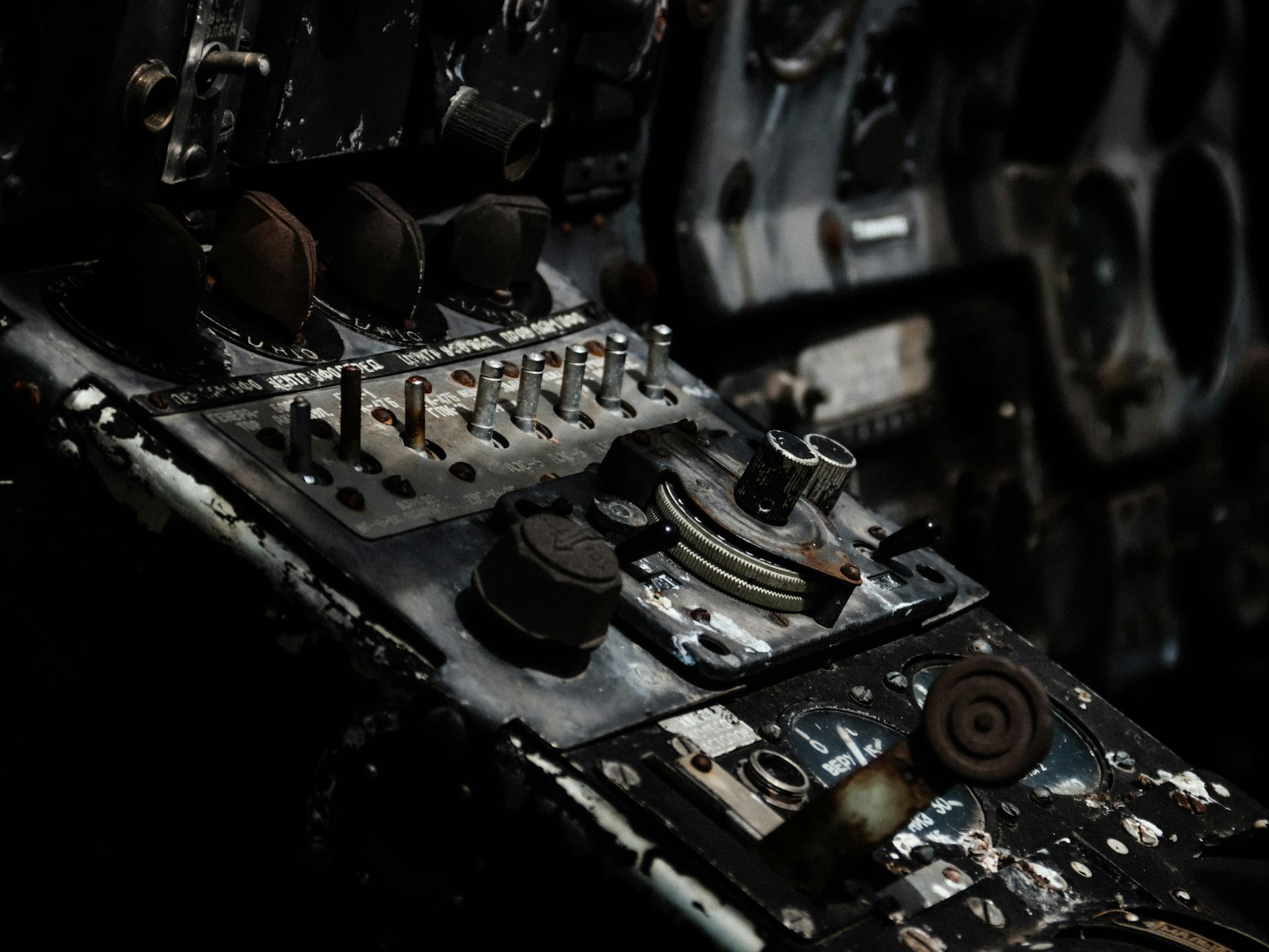 Detailed view of an old airplane cockpit showcasing knobs and dials, evoking nostalgia and history.