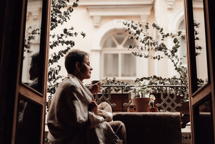 Woman Drinking Tea On Balcony