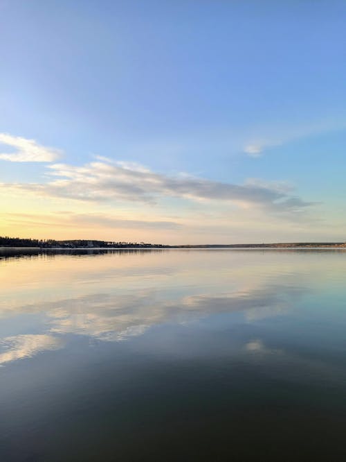 Body of Water Under Blue Sky