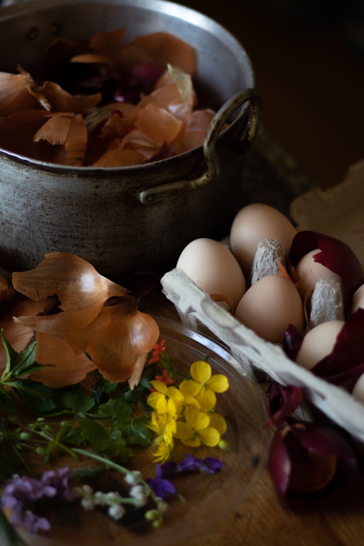 Onion Peels In Pot Near Eggs And Wildflowers