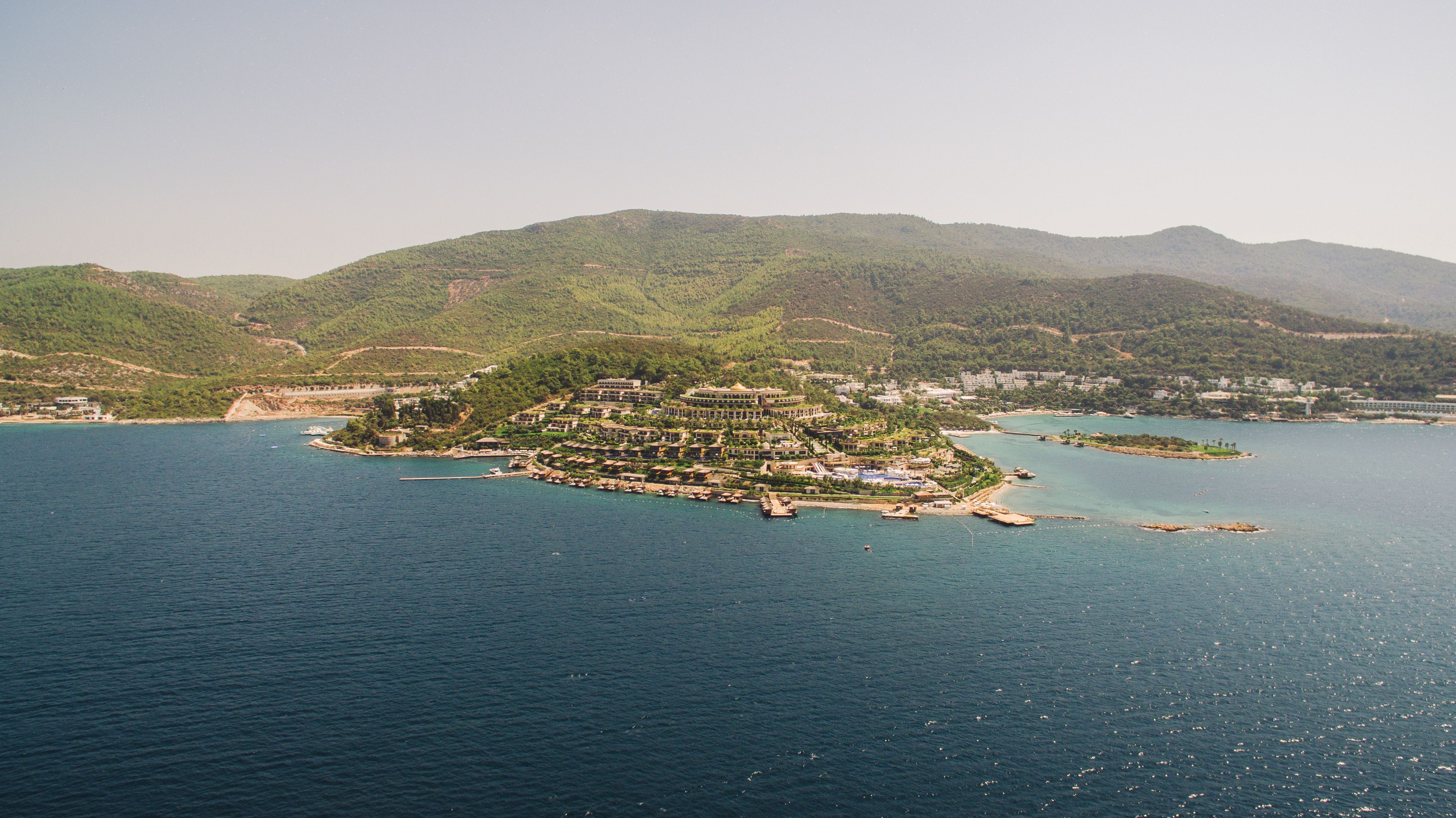 Incredible A Majestic Helicopter Tour in Istanbul Review: Soaring Over Two Continents Review 2026 - A stunning aerial view of a resort island surrounded by blue ocean and lush green landscapes.