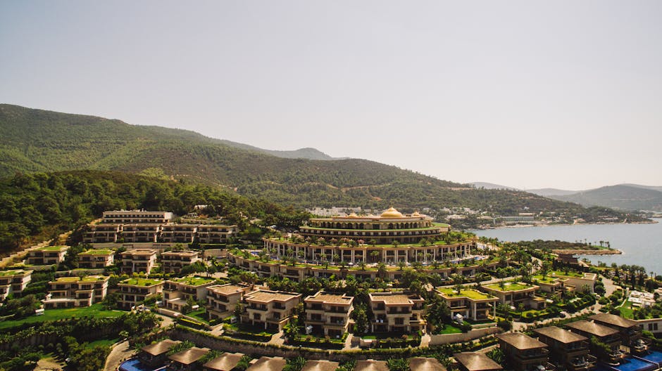 Stunning aerial view of a luxurious resort by Torba Bay amid lush hills in Bodrum, Turkey.
