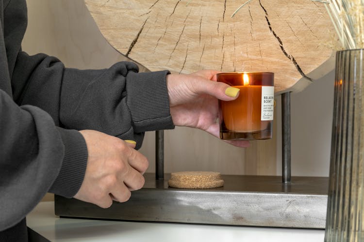 Person Holding Burning Candle 