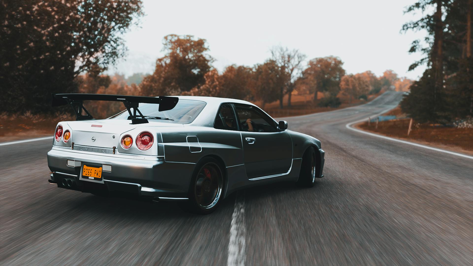 Gray Nissan Skyline Drifting on Road