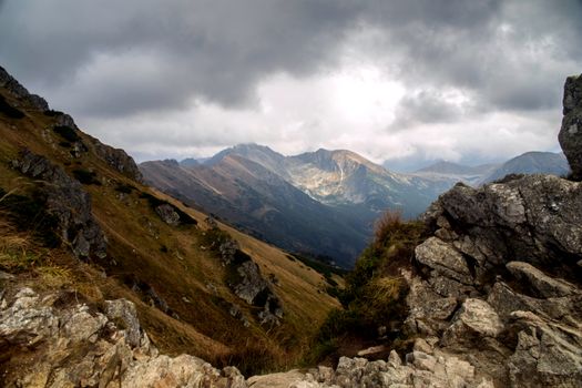 Stunning dramatic view of rugged mountains and cloudy sky in a natural landscape.