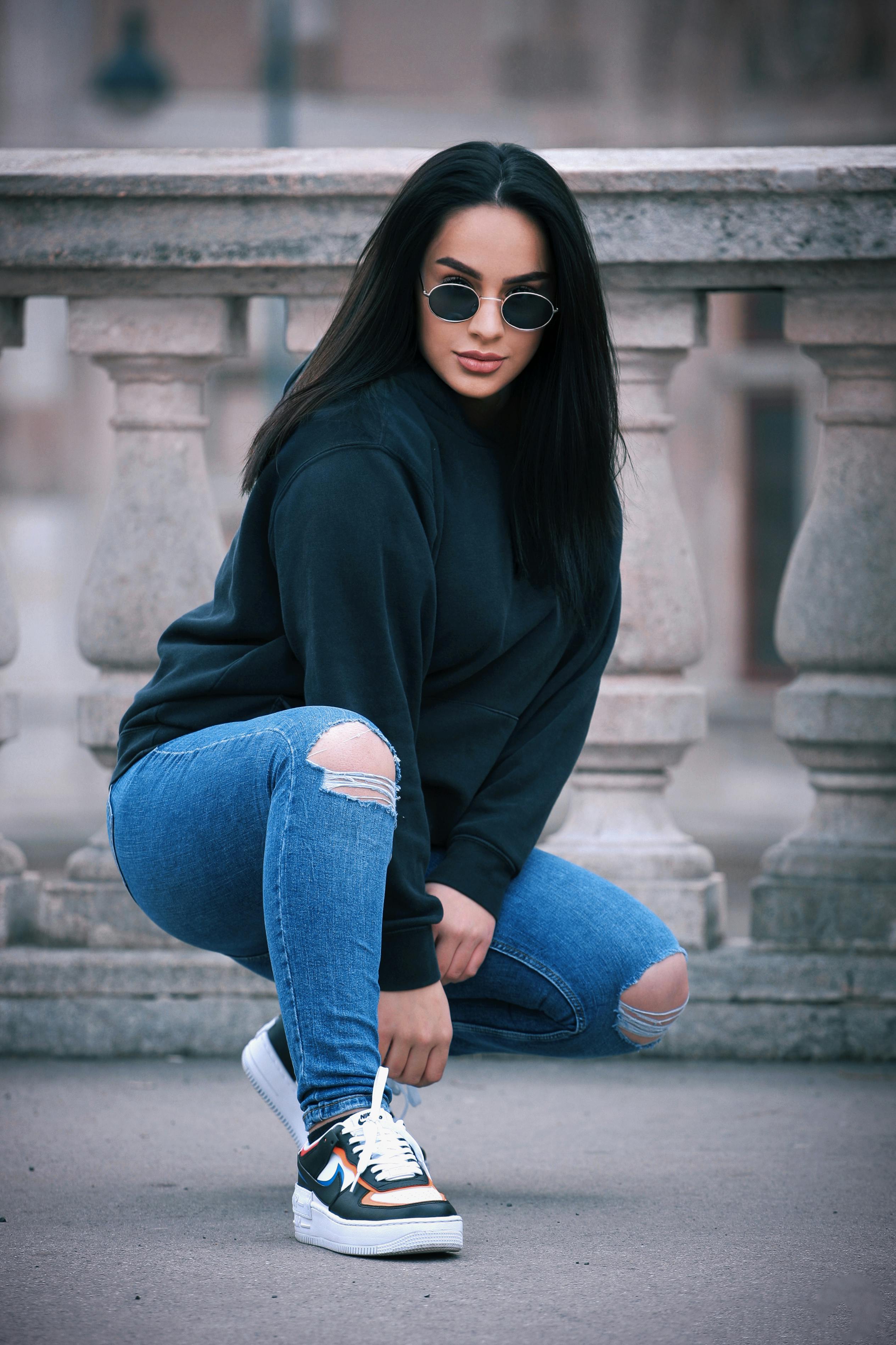 Photo of a Woman Wearing a Black Sweatshirt and Blue Denim Jeans · Free  Stock Photo