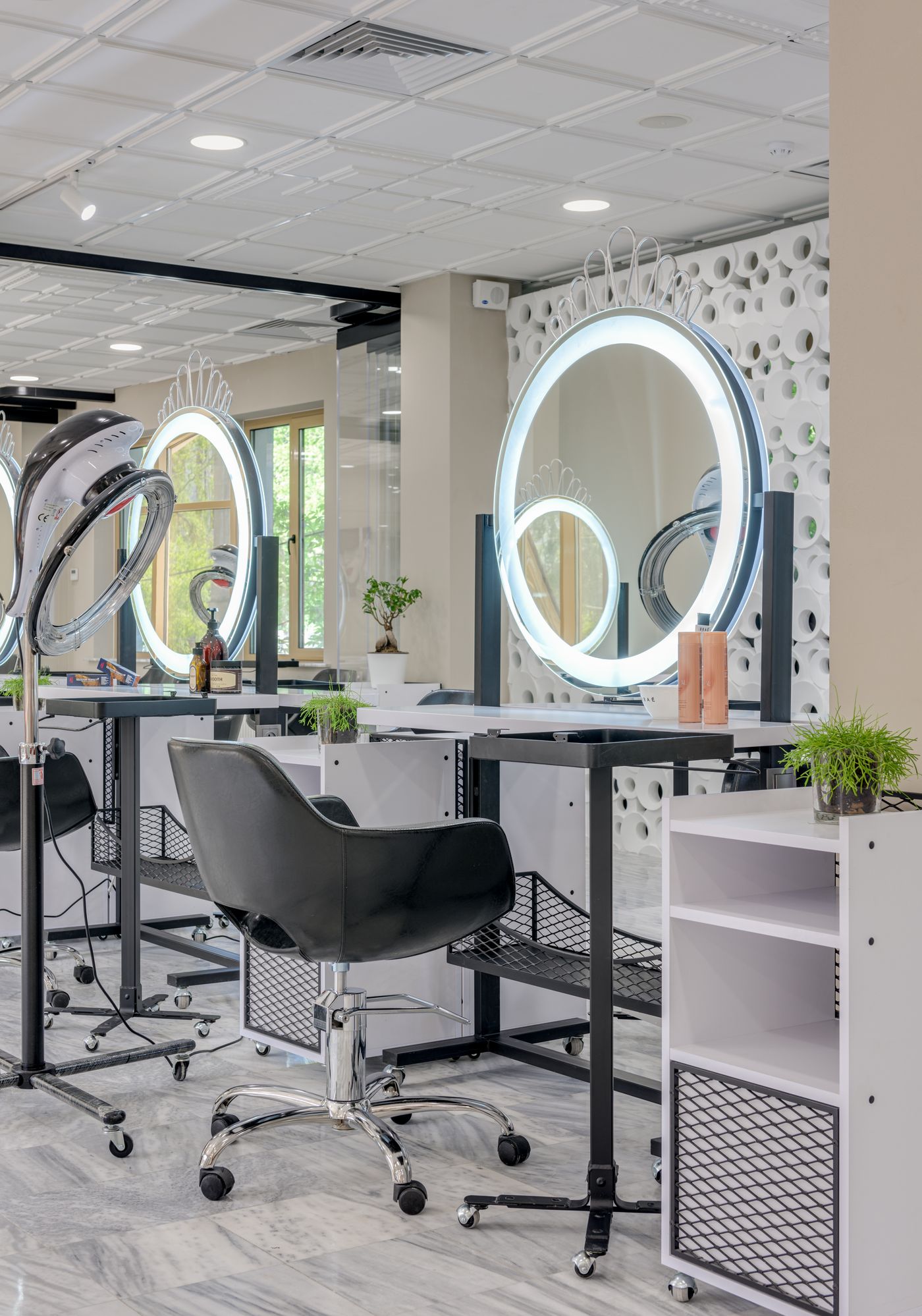 Elegant salon interior with illuminated mirrors and marble finishes