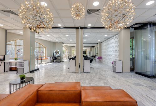 Free Bright and spacious beauty salon lobby with stylish decor and modern lighting features. Stock Photo