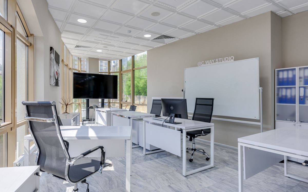 Spacious and bright modern office interior with sleek furniture, ideal for professional workspaces.